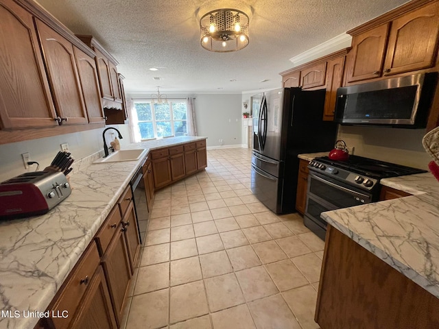 kitchen featuring sink, light tile patterned floors, black appliances, and a textured ceiling