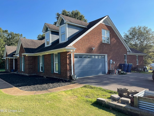 view of home's exterior with a garage and a yard