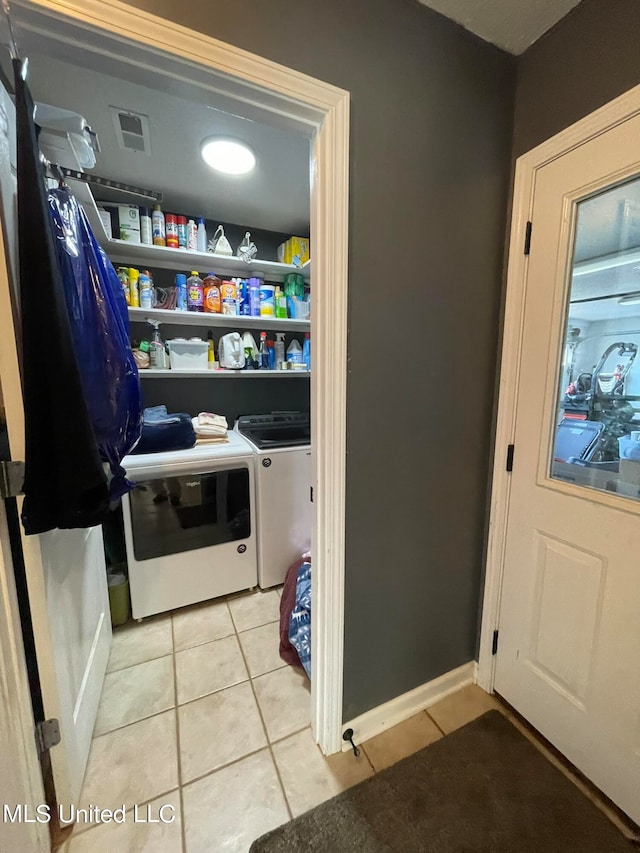 pantry featuring washing machine and clothes dryer