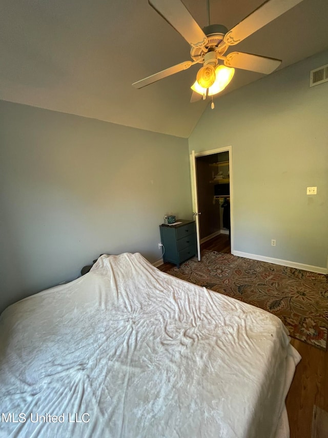 bedroom with lofted ceiling, a closet, and ceiling fan