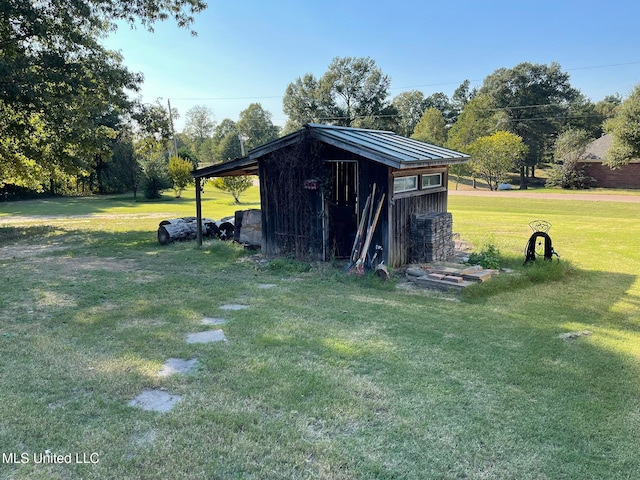 view of outbuilding featuring a yard