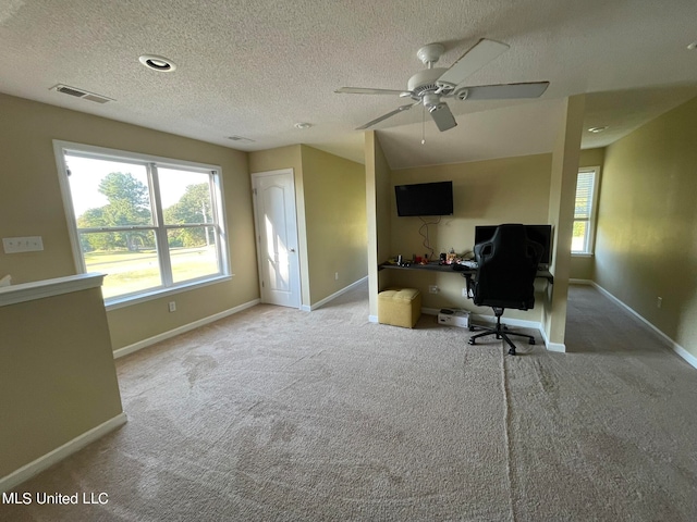 carpeted office featuring a textured ceiling