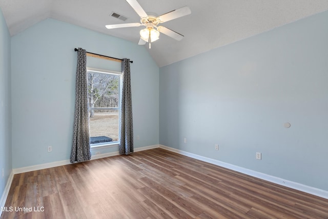 empty room featuring lofted ceiling, wood-type flooring, and ceiling fan