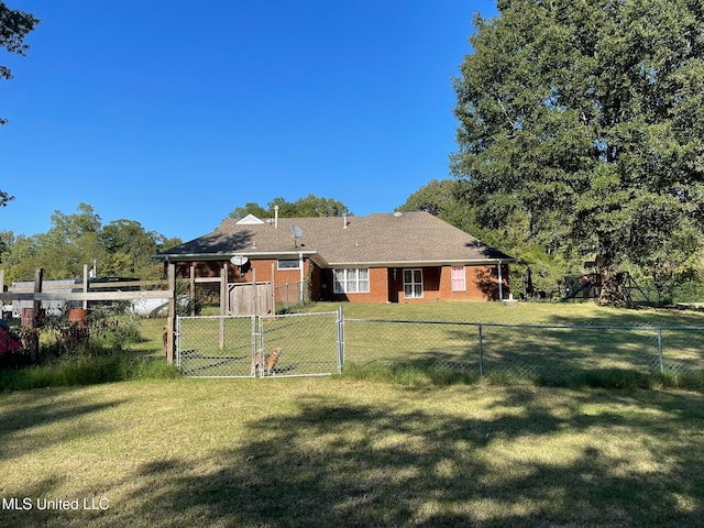 rear view of property with a lawn