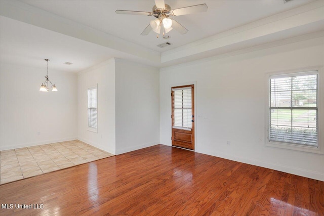 409 Sand Stone Pl, Brandon, MS 39042 - empty room featuring plenty of natural light, wood finished floors, and a chandelier