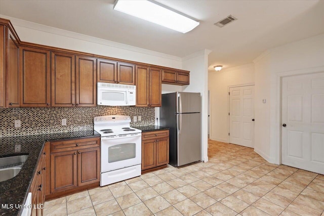 409 Sand Stone Pl, Brandon, MS 39042 - kitchen featuring white appliances, decorative backsplash, brown cabinetry, crown molding, and dark stone counters