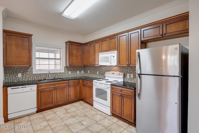 409 Sand Stone Pl, Brandon, MS 39042 - kitchen featuring white appliances, dark countertops, decorative backsplash, brown cabinetry, and ornamental molding