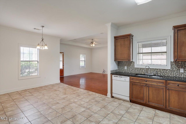 409 Sand Stone Pl, Brandon, MS 39042 - kitchen featuring dishwasher, dark countertops, decorative backsplash, ornamental molding, and a chandelier