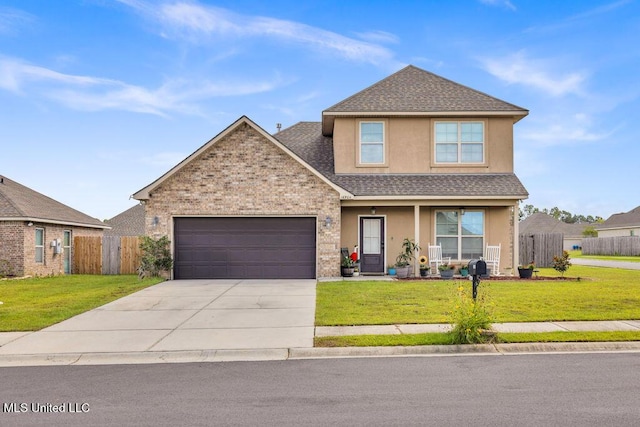 16904 Desmare St, Gulfport, MS 39503 - traditional home featuring roof with shingles, an attached garage, concrete driveway, covered porch, and stucco siding