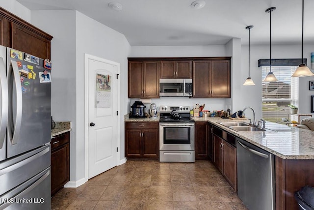 16904 Desmare St, Gulfport, MS 39503 - kitchen with appliances with stainless steel finishes, light stone countertops, dark brown cabinetry, and a peninsula
