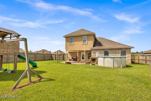 16904 Desmare St, Gulfport, MS 39503 - rear view of property with a playground, a fenced backyard, stucco siding, brick siding, and a fire pit