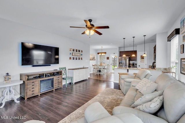 16904 Desmare St, Gulfport, MS 39503 - living room featuring a ceiling fan, dark wood-style floors, and a chandelier