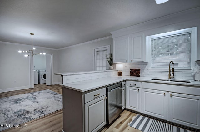 311 Danbar St, Brandon, MS 39042 - kitchen with a sink, dishwasher, washer and dryer, a peninsula, and light wood-style floors