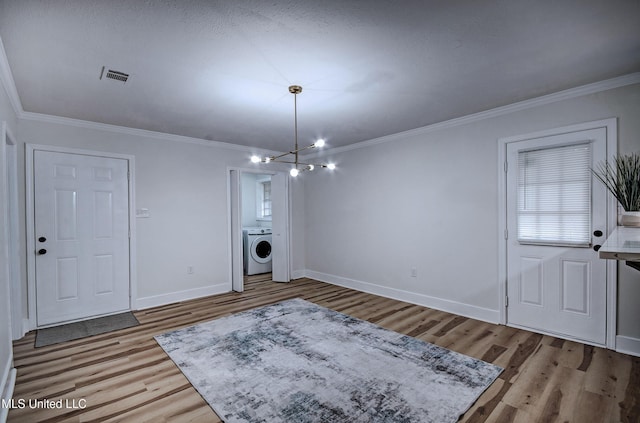 311 Danbar St, Brandon, MS 39042 - entryway with washer / clothes dryer, wood finished floors, crown molding, baseboards, and a chandelier