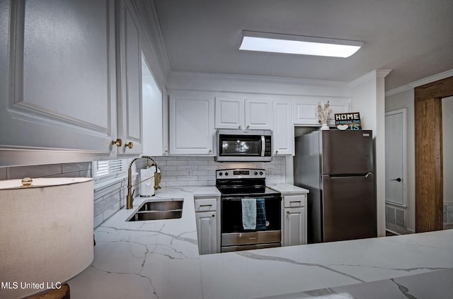 311 Danbar St, Brandon, MS 39042 - kitchen with stainless steel appliances, a sink, light stone counters, white cabinets, and tasteful backsplash