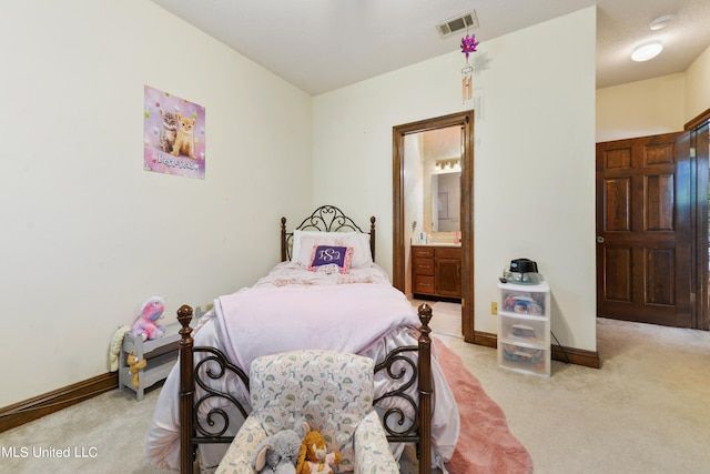 carpeted bedroom featuring ensuite bathroom