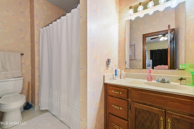 bathroom with toilet, ceiling fan, a shower with curtain, vanity, and tile patterned flooring