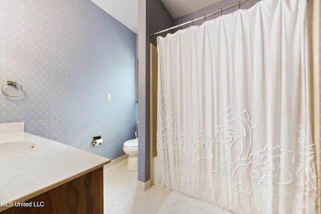 bathroom featuring toilet, vanity, tile patterned floors, and a shower with shower curtain