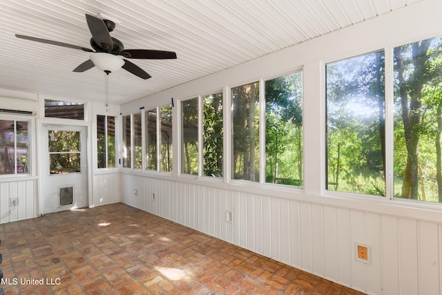 unfurnished sunroom with ceiling fan