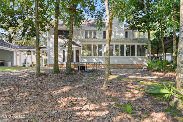 rear view of house featuring a balcony