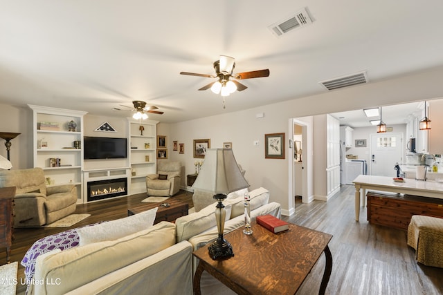 living room with wood-type flooring and ceiling fan