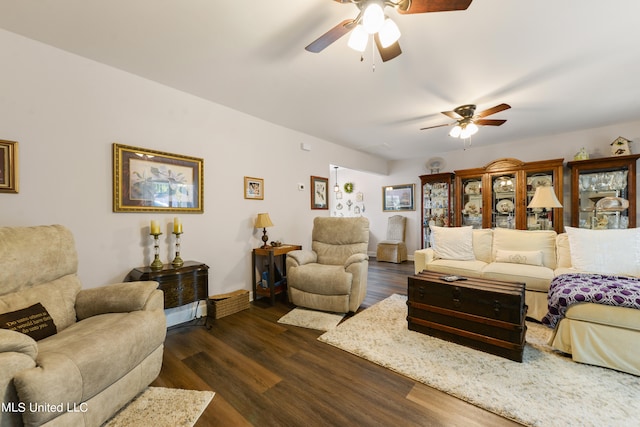 living room featuring ceiling fan and dark hardwood / wood-style flooring