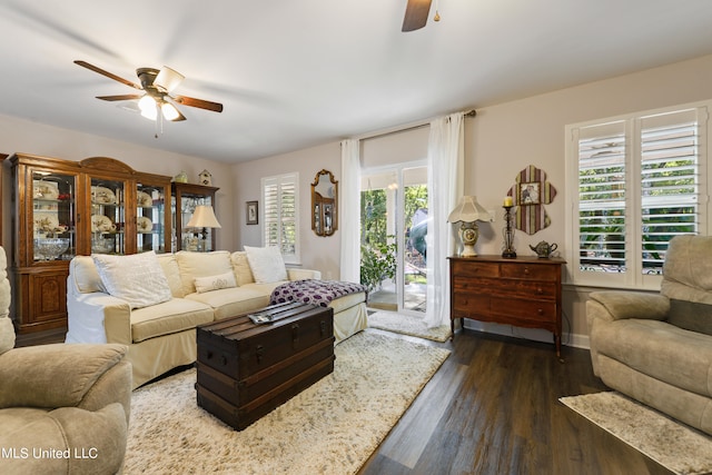 living room with ceiling fan, a wealth of natural light, and dark hardwood / wood-style floors