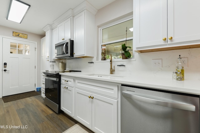 kitchen featuring white cabinetry, stainless steel appliances, sink, and dark hardwood / wood-style flooring