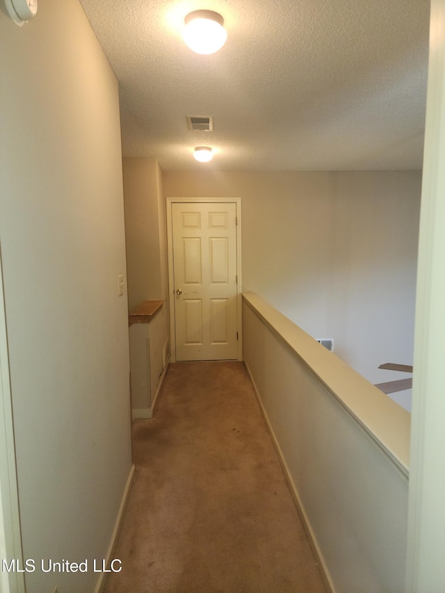 7295 Madelyn Cv, Horn Lake, MS 38637 - hall featuring a textured ceiling, light carpet, and an upstairs landing