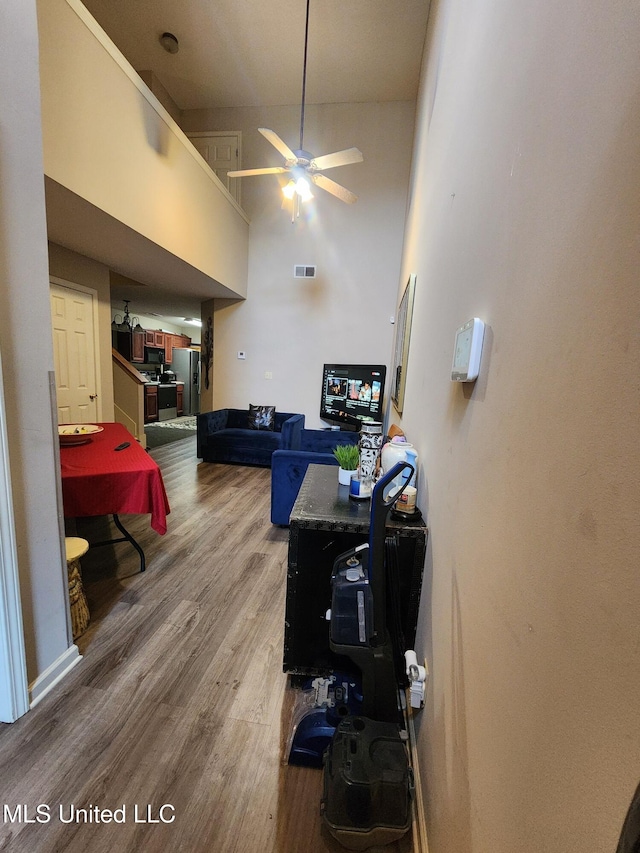 7295 Madelyn Cv, Horn Lake, MS 38637 - living area featuring wood finished floors, ceiling fan, and a high ceiling
