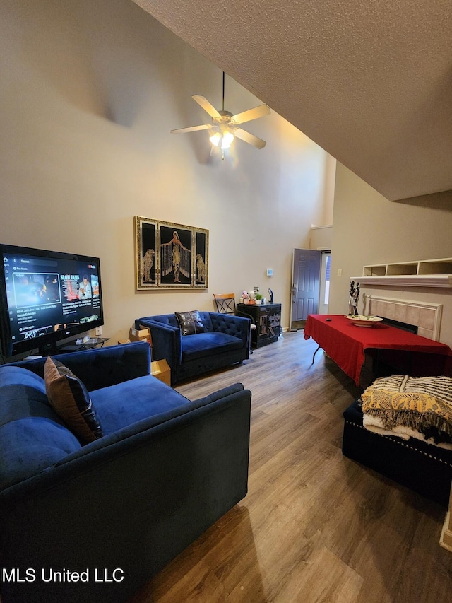 7295 Madelyn Cv, Horn Lake, MS 38637 - living area with wood finished floors, billiards, a ceiling fan, a textured ceiling, and high vaulted ceiling