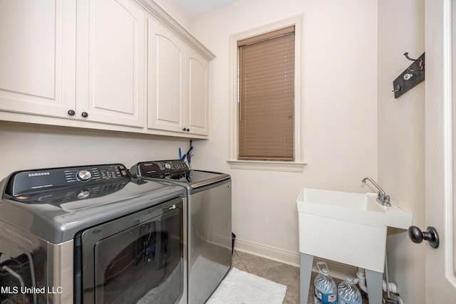 3927 Acadian Village Dr, Ocean Springs, MS 39564 - washroom featuring washer and dryer, cabinet space, and light tile patterned floors