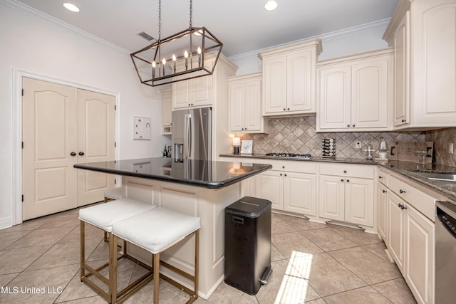 3927 Acadian Village Dr, Ocean Springs, MS 39564 - kitchen with appliances with stainless steel finishes, a chandelier, crown molding, light tile patterned floors, and tasteful backsplash