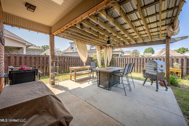 3927 Acadian Village Dr, Ocean Springs, MS 39564 - fenced backyard featuring a patio, outdoor dining space, and grilling area