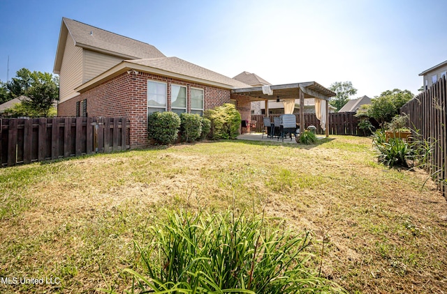 3927 Acadian Village Dr, Ocean Springs, MS 39564 - rear view of property featuring brick siding, a patio, and a fenced backyard