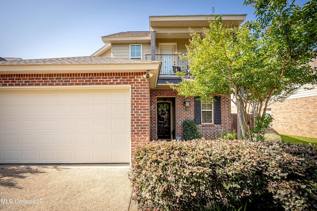3927 Acadian Village Dr, Ocean Springs, MS 39564 - view of front of house with a balcony, brick siding, an attached garage, concrete driveway, and roof with shingles
