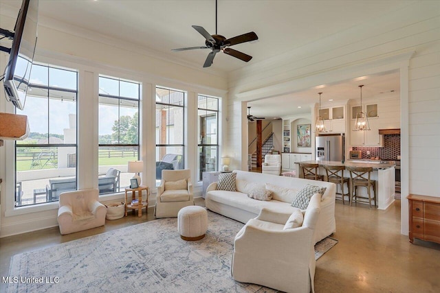 110 Crossview Pl, Brandon, MS 39047 - living area with plenty of natural light, ceiling fan, stairway, and finished concrete floors