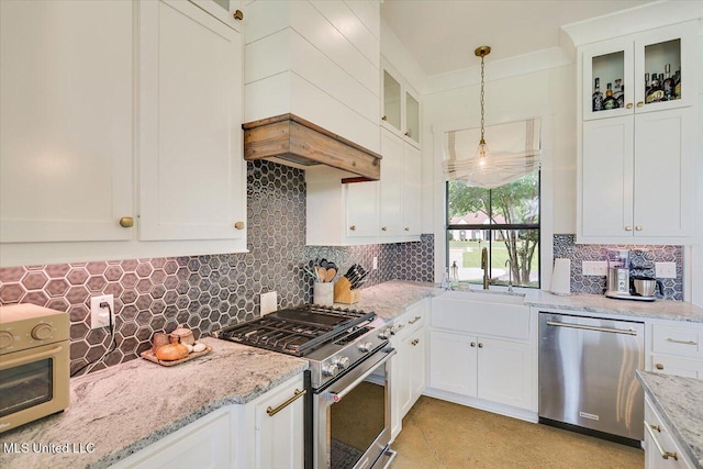110 Crossview Pl, Brandon, MS 39047 - kitchen with appliances with stainless steel finishes, hanging light fixtures, tasteful backsplash, white cabinets, and light stone counters