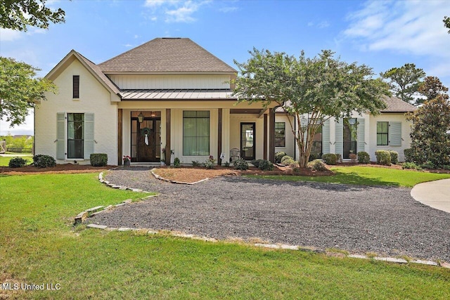 110 Crossview Pl, Brandon, MS 39047 - view of front of home featuring a standing seam roof, a front lawn, roof with shingles, a metal roof, and covered porch