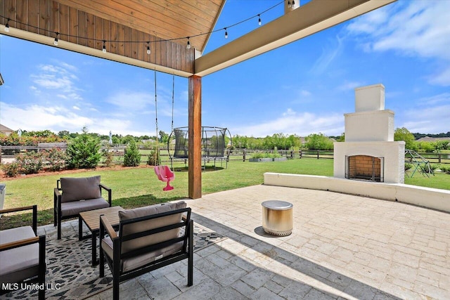 110 Crossview Pl, Brandon, MS 39047 - view of patio featuring a trampoline and an outdoor living space with a fireplace