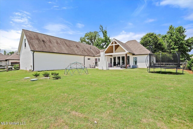 110 Crossview Pl, Brandon, MS 39047 - back of property with a trampoline, a lawn, a patio area, and a shingled roof