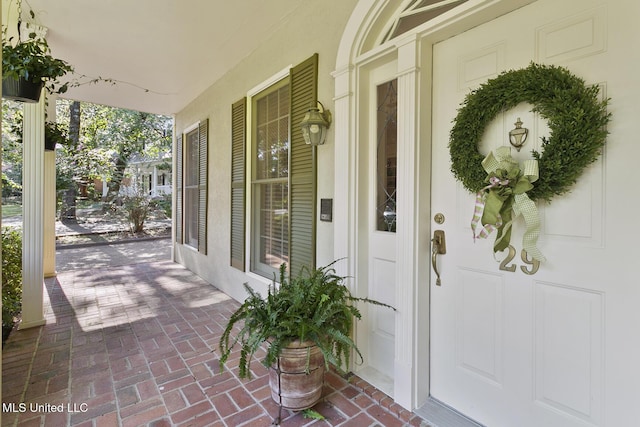 29 Avery Cir, Jackson, MS 39211 - doorway to property featuring a porch and stucco siding