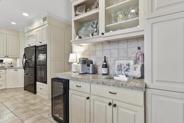 29 Avery Cir, Jackson, MS 39211 - kitchen with wine cooler, light tile patterned floors, decorative backsplash, black appliances, and ornamental molding