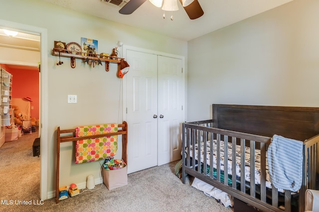 14906 Angela Dr, Gulfport, MS 39503 - carpeted bedroom featuring a closet, a crib, and a ceiling fan