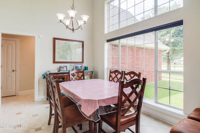 2901 Village Cir, Ocean Springs, MS 39564 - dining space featuring a chandelier, light tile patterned floors, and a high ceiling