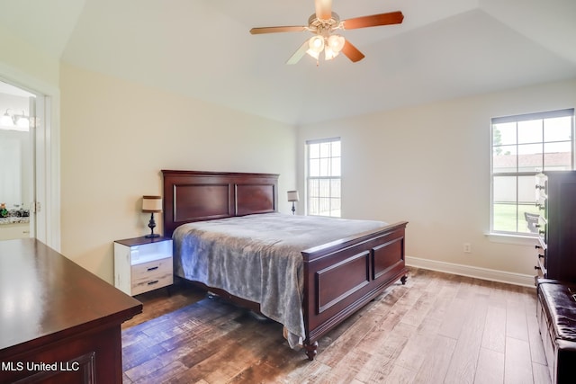 2901 Village Cir, Ocean Springs, MS 39564 - bedroom with vaulted ceiling, dark wood-style floors, multiple windows, and ceiling fan