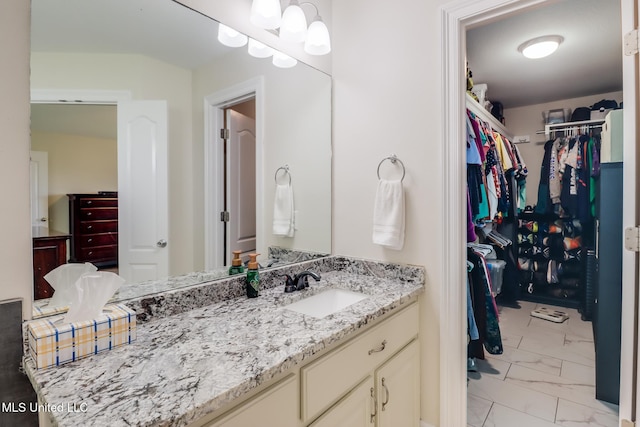 2901 Village Cir, Ocean Springs, MS 39564 - bathroom with marble look tile flooring, vanity, and a spacious closet
