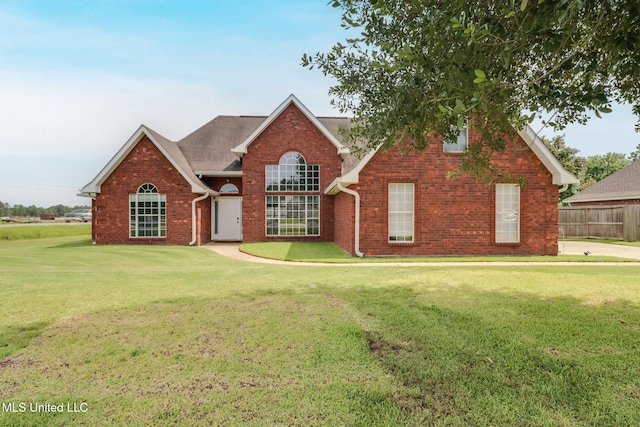 2901 Village Cir, Ocean Springs, MS 39564 - traditional-style home with a front yard, brick siding, and a shingled roof