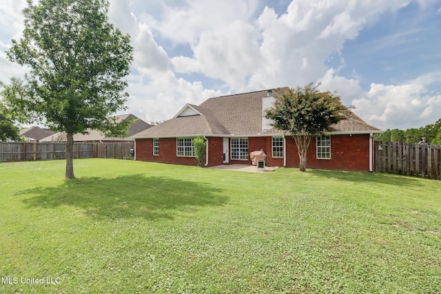 2901 Village Cir, Ocean Springs, MS 39564 - back of property featuring a fenced backyard, brick siding, a patio area, and roof with shingles