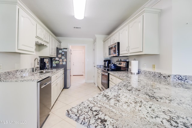 2901 Village Cir, Ocean Springs, MS 39564 - kitchen featuring stainless steel appliances, light tile patterned floors, crown molding, white cabinets, and light stone countertops